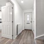 Bright modern hallway with wooden flooring.