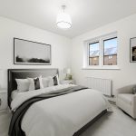 Modern bedroom with double bed and artwork.