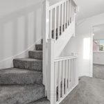 Carpeted staircase in modern home interior