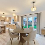 Modern kitchen with dining area and patio view.