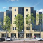 Modern office building with parked cars and trees.
