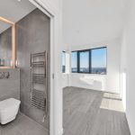 Modern bathroom and bright room with city view.