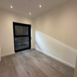 Empty room with wooden floor and window.