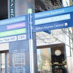 Milton Keynes signs to shopping and station square.
