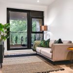 Modern living room with sofa and balcony view.