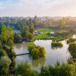Aerial view of scenic countryside with lake and trees.