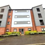 Modern apartment building with brick and grey facade.
