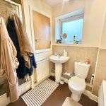 Modern bathroom with towels and toiletries.