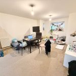 Cosy living room with desk, toys, and decorations.