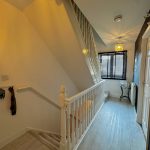 Modern hallway with staircase and window blinds