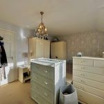 Elegant nursery room with vintage furniture and wallpaper.