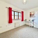 Minimalistic room with red curtains and desk