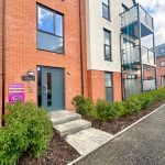 Modern flat exterior with sold sign