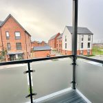 View from balcony overlooking residential street.