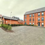 Modern red-brick apartments with car park