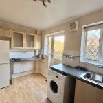 Bright kitchen with appliances and garden view