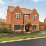 New brick detached house on residential street