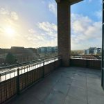 Sunny urban view from balcony at sunrise.