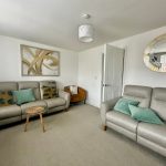 Modern living room with grey sofas and decor.