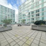 Modern courtyard with seating and greenery.