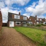 Brick house with front garden and driveway