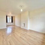 Spacious empty living room with wooden floor