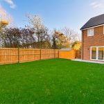 Modern house with spacious backyard and wooden shed.