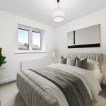 Modern bedroom with grey bedding and decor.