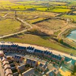 Aerial view of housing estate and surrounding countryside.