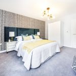 Stylish modern bedroom with patterned wallpaper.