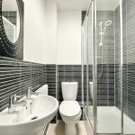 Modern bathroom with black and white tiles.