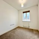Empty room with carpet and window view.