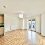 Spacious modern flat with kitchen and balcony access.