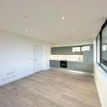 Modern open-plan kitchen with large windows.