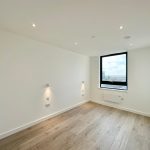 Empty modern room with wooden flooring and window