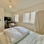 Bright bedroom with computer desk and bed