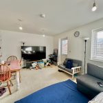 Modern family living room with toys and dining area.