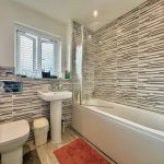 Modern bathroom with striped tile design.