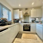 Modern white kitchen with oven and sink