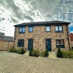 Modern brick semi-detached house under cloudy sky