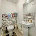 Modern bathroom with toilet and sink.