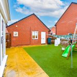 Backyard with slide, clothesline, and artificial grass