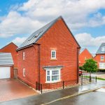 Red brick houses on rainy residential street.