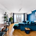 Modern living room with blue sofa and decor.