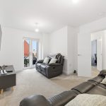 Modern living room with leather sofas and TV