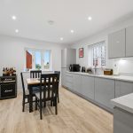 Modern kitchen with dining area and guitar amplifier