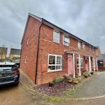 Modern semi-detached brick house with driveway.