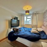 Cosy bedroom with cat on bed