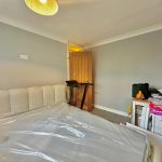 Bedroom with bed and cluttered desk