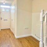 Hallway with wooden floor and staircase